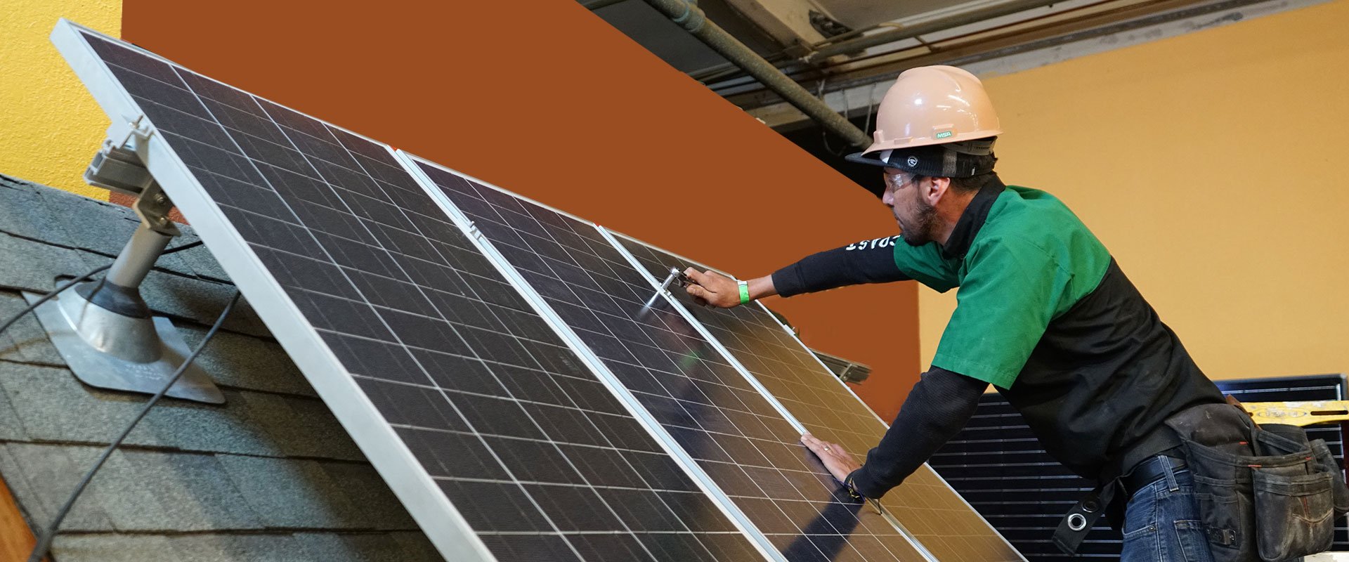 photo of student installing solar panels at CET